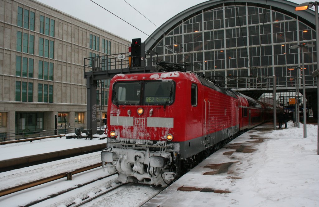 DB 112 102-9 with RE2 towards Rathenow at the snowy day on 10.1.2010 at Berlin-Alexanderplatz. 