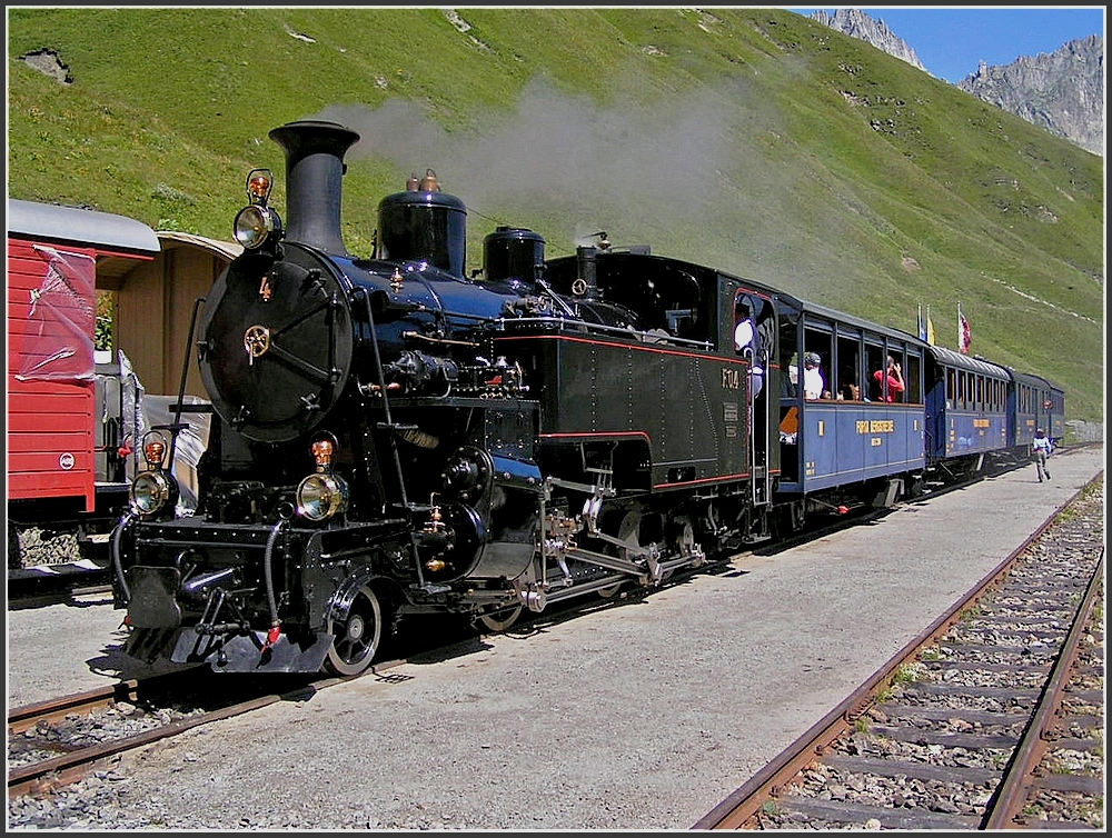 DFB steam locomotive HG 3/4 Nr 4 with heritage wagons photographed at station Furka on August 1st, 2007.