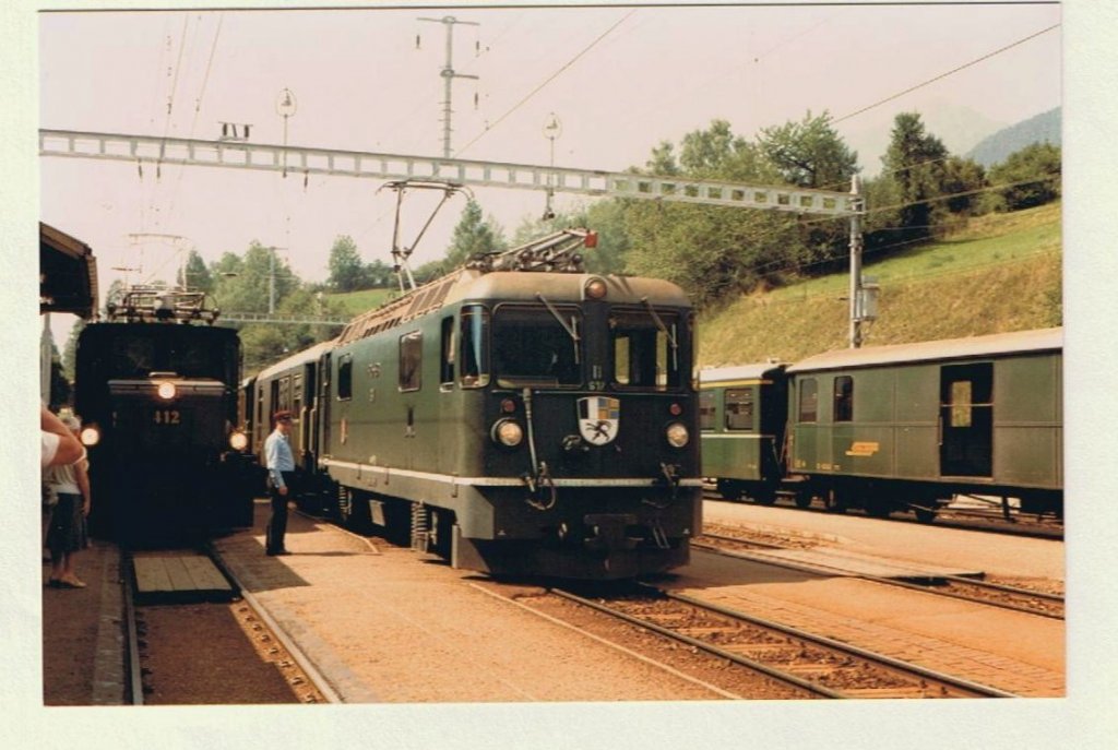 Ge 6/6 I with a Cargo train and Ge 4/4 II with a fast train to st.Moritz in Filisur. 
20.08.1984
(scanned analog photo)