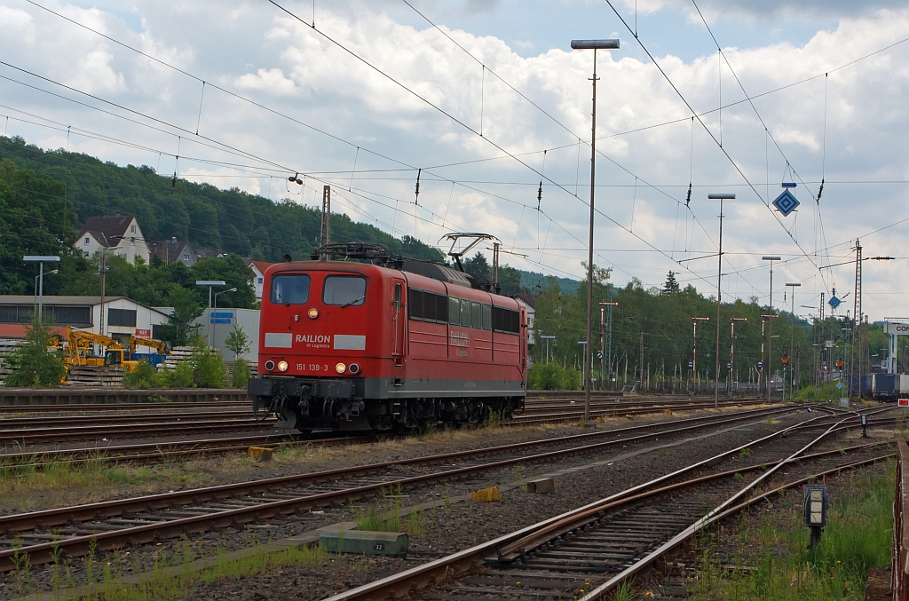 German electric locomotive 151 139-3 from the RAILION Logistics on 05/28/2011 in Kreuztal, the locomotive was parked and now drives toward Marshalling yard.