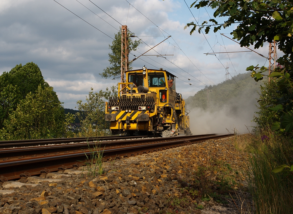 German Plasser Ballast Distributing and Profiling Machine SSP 110 SW (heavy vehicle no. 97 16 40 512 18-4) of the Schweerbau, at the 29.07.2011 on the KBS 445 in Wilnsdorf Anzhausen at work, in the final meters.