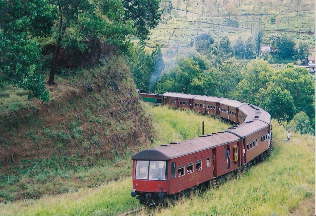 Henschel Thyssen Class M6 - 796 locomotive heading to Badulla is negotiating the  last lap of the S curve in Rozalla incline. the station is visible on top right side of the picture. Note - this is a continuation of picture token 14845.