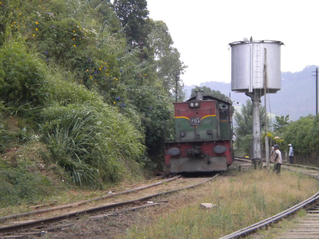 Henschel Thyssen Class M6 794 pulling a mix train approaching Bandarawela in 2012 Aug. the water tank which was heavily used when steam locos were running is on the side of the track.