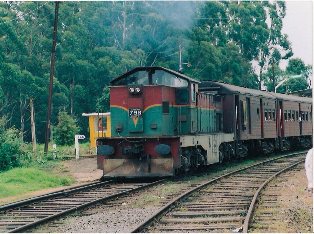 Henschel Thyssen Class M6 796 just started moving out of Ambewela station in hill country of Sri Lanka on 15th April 2012. The long journey from Colombo will end up in Badulla which is few station away.139 ¼ mile post is visible on the left side of the picture which is the distance from Colombo. The total distance Badulla terminus is 187 miles.