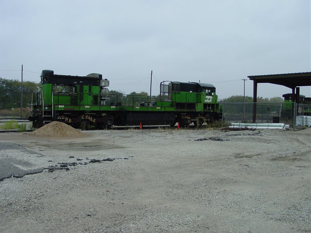 Here at the West Burlington, Iowa Shops sits the remains of a Burlington Northern 5500 series locomotive (C30-7). Units were scrapped, or sent to China, if the fuel mileage was not up to government standards. New Years day 2001.