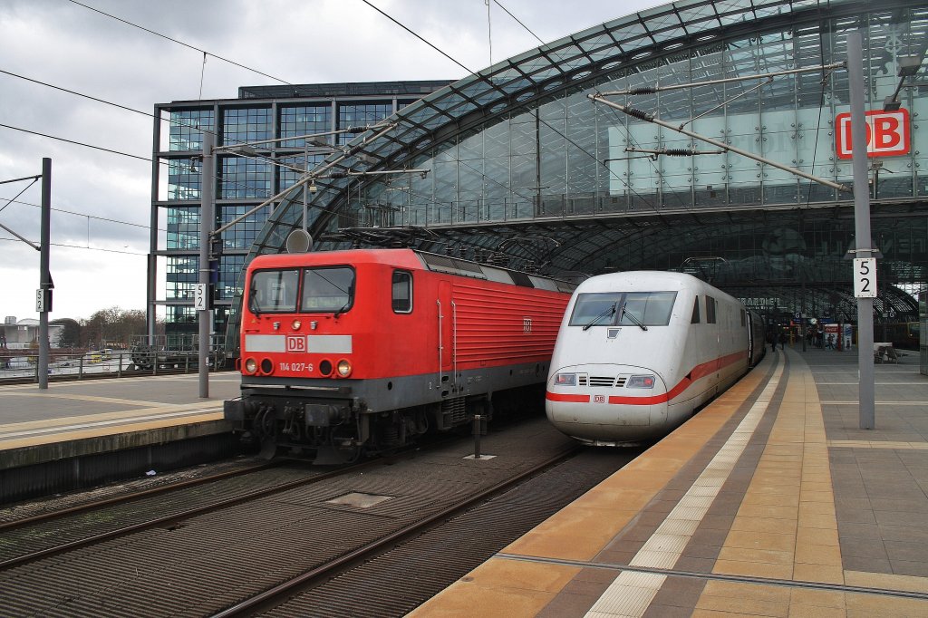 On the left site 114 027-6 with a local train from Berlin Charlottenburg to Frankfurt(Oder) and on the right site 401 056-7  Heppenheim/Bergstraße  as ICE691 from Berlin Ostbahnhof to Stuttgart main station. Berlin main station, 25.2.2012.