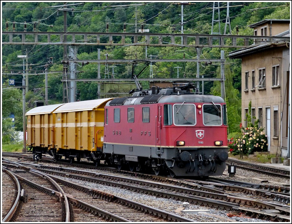 Re 4/4 II 11180 is running through the station of Brig on May 22nd, 2012.