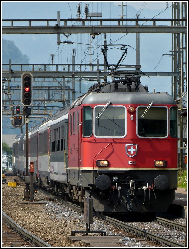 Re 4/4 II 11222 with an IR to Locarno is entering into the station of Erstfeld on May 24th, 2012.