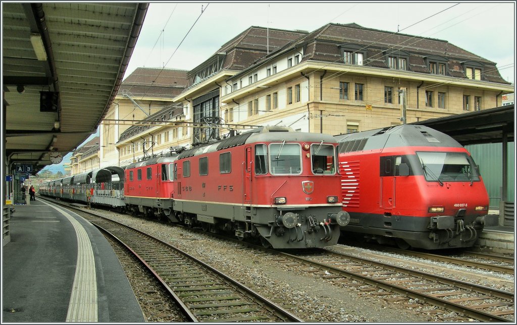 SBB Re 4/4 II 11147 and an other one with a new Simplon Tunnel Train in Lausanne. 
04.04.2011