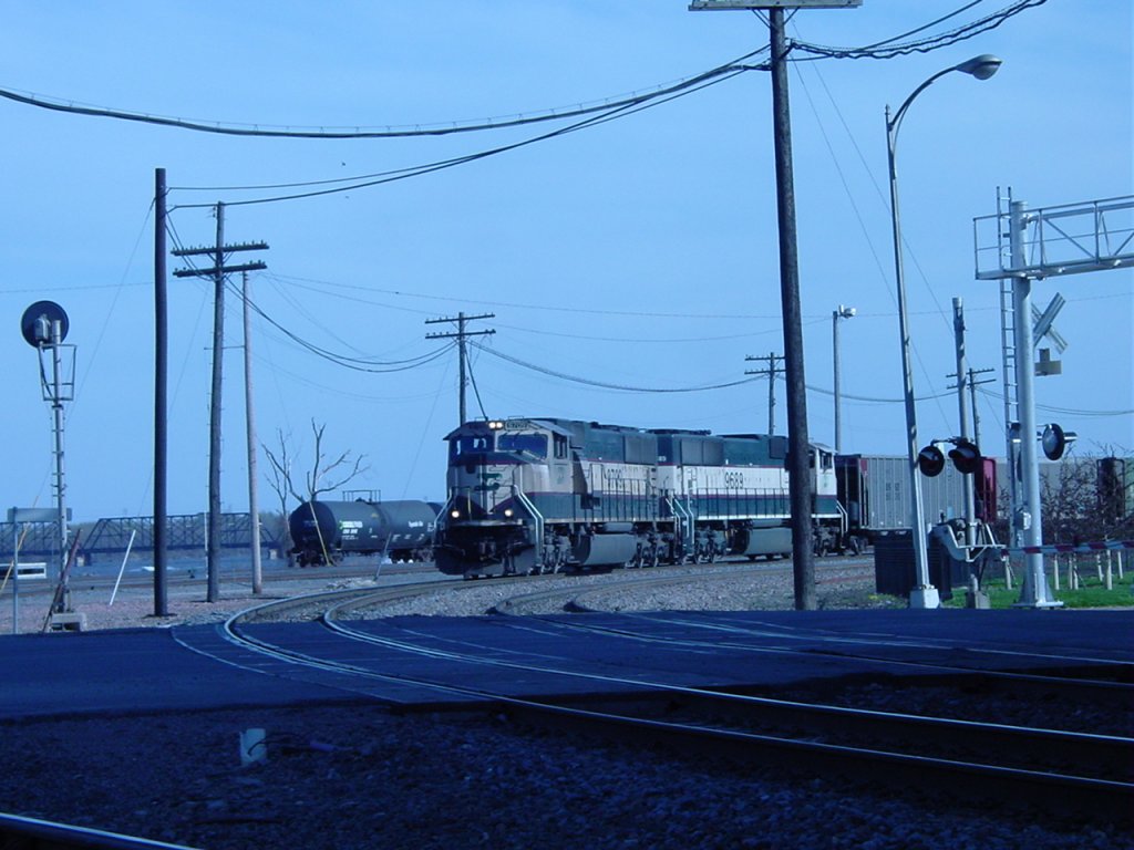 SD70MAC with Burlington Northern paint are about to roll thru the Main Street crossing in Burlington, Iowa on 9 Apr 2005. The photographer turned 47 on this day.