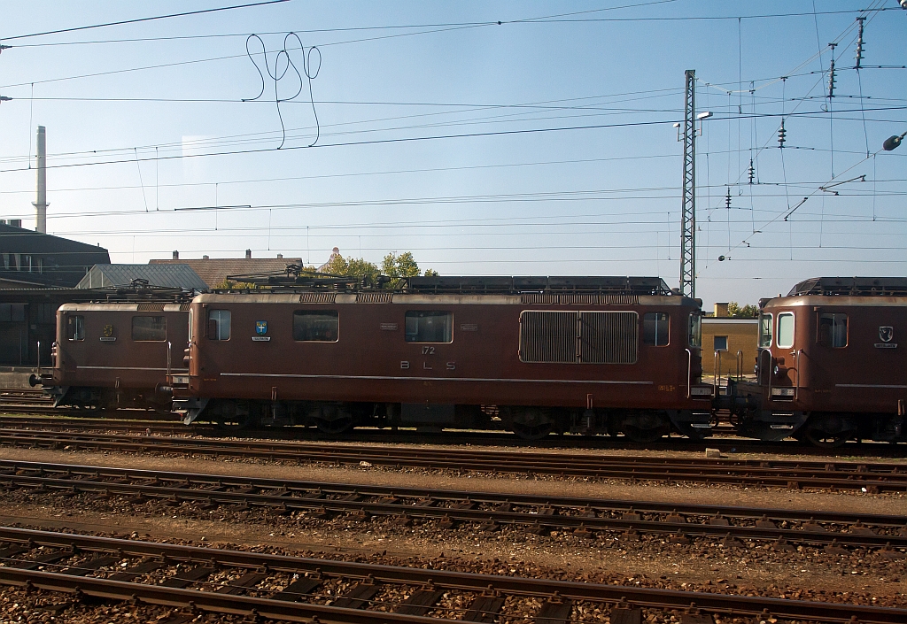 Swiss electric locomotives Re 4/4 of the BLS parked on 30.09.2011 in Basel Bad Station. Photographed out of a moving ICE.