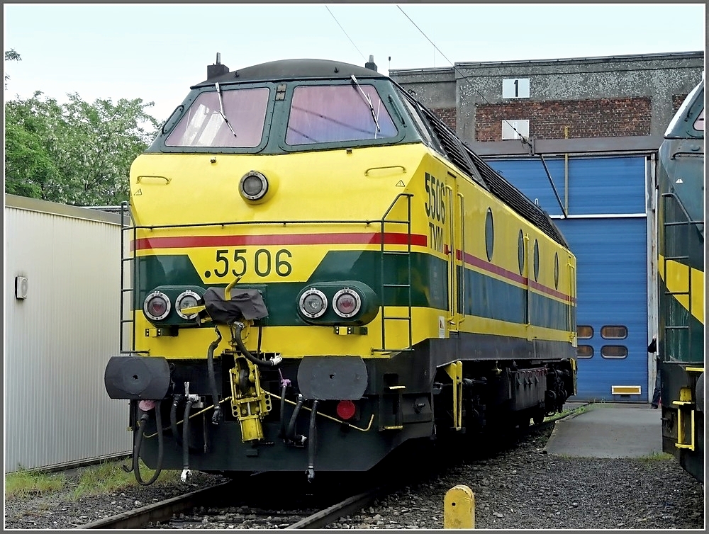 The diesel locomotive 5506 pictured in front of the depot Kinkempois on May 18th, 2008. These engines were provided in operation by the SNCB in the years 1961-1962, they particularly run in the south of Belgium. The point before the number means that this locomotive has a heater. On the red stripes and the words TVM can be seen, that this engine can reach a speed of 200 km/h and is allowed to ride on the high speed line between Liège and Louvain to tow wrecked high speed trains. Various locomotives of this series also have the words L2, then they can go up to St Louis (France). 