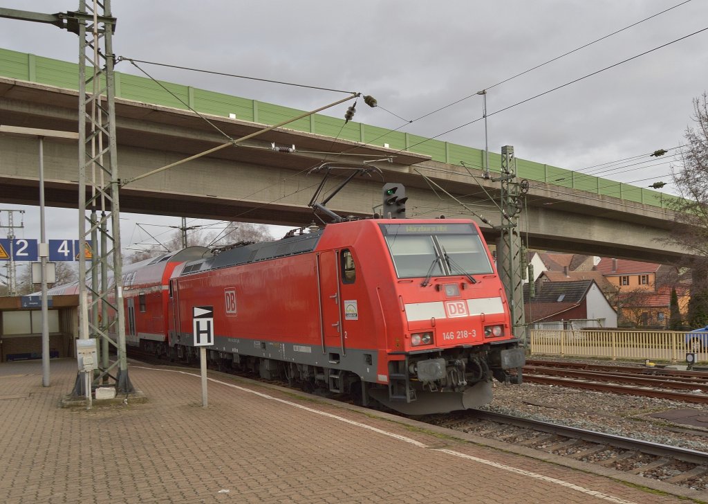 The electricale locomotive class 146 218-8 pusches the RB 69474 out of the station of Osterburken to it's destination Wrzburg Hbf at the silvestersday 31.12.2012