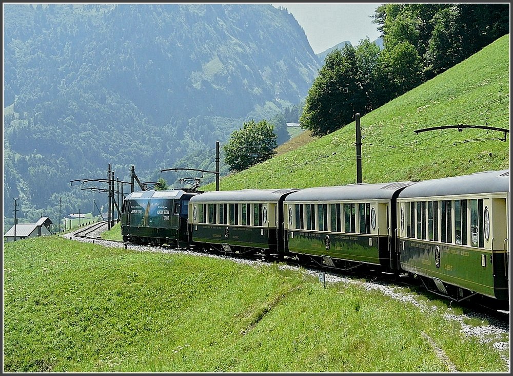 The GoldenPass classic train with Pullman wagons  Belle Epoque  is running between Gstaad and Chteau d'Oex on July 31st, 2008.