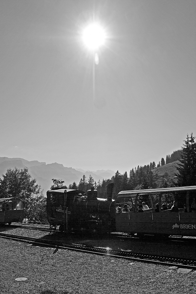 The heating oil-fired BRB 16 (Brienz Rothornbahn) on 01.10.2011 at the station Planalp (1346 m above sea level), here in full against the light.