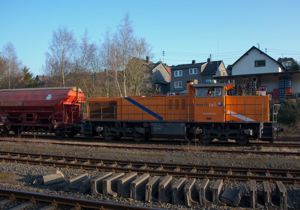 The Kreisbahn Siegen-Wittgenstein (KSW) with the north rail - rent locomotive, a MaK G 1206 on  03.03.2011 at the station Herdorf. The locomotive with freight train waits on free signal to continue in the direction of Betzdorf.