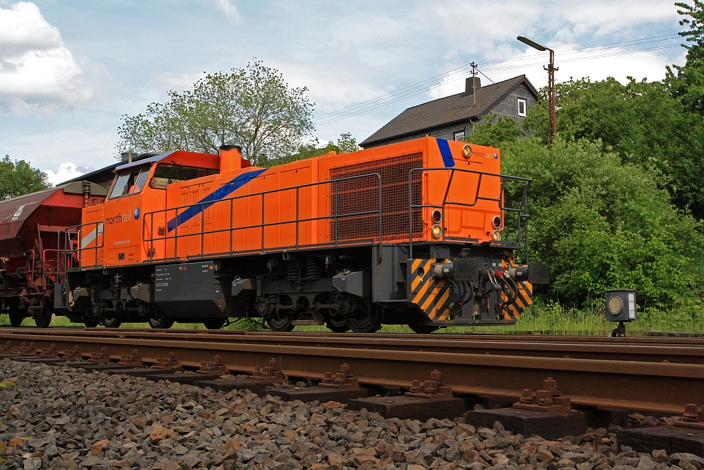 The Kreisbahn Siegen-Wittgenstein (KSW) with the northrail rental locomotive a MaK G 1206 on 18.05.2011 behindsignal box Herdorf East (Ho). The locomotive with a freight train (empty) for transfer journey towards Betzdorf/Sieg (Germany).