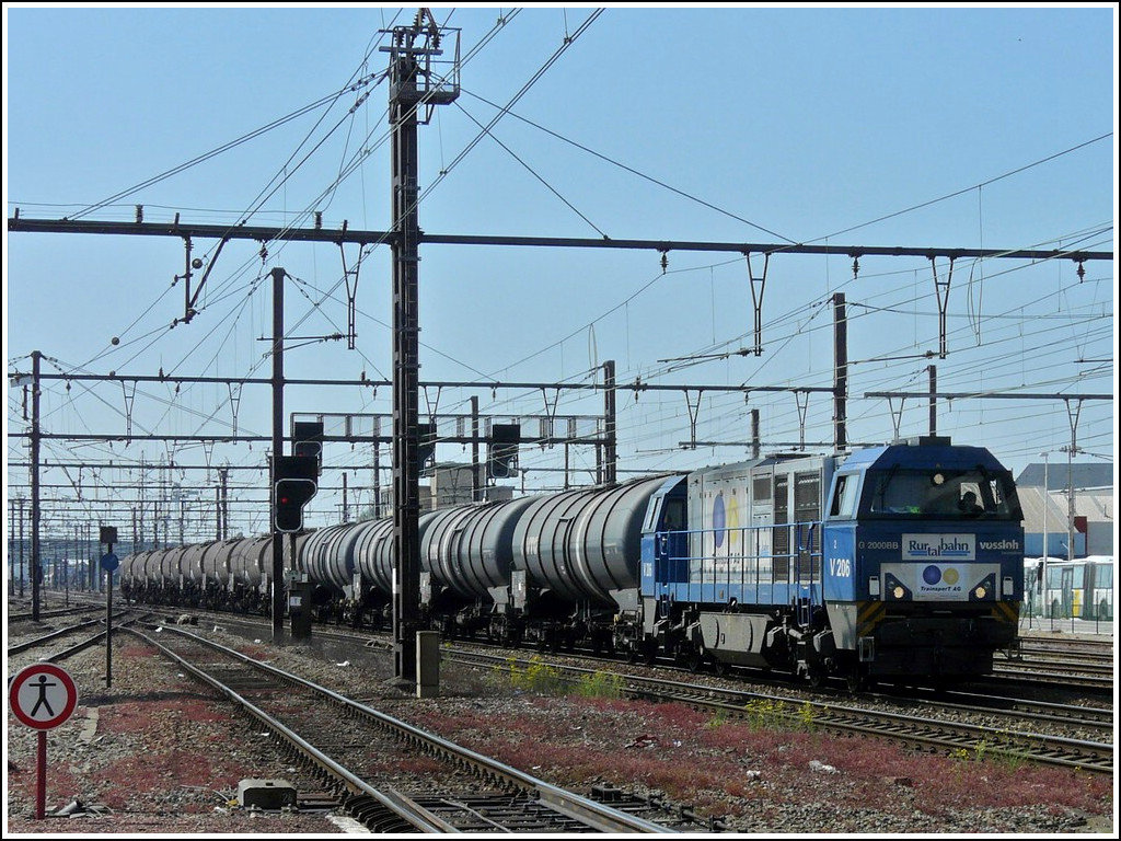 The MaK G 2000 BB Rurtalbahn V 206 is hauling a goods train through the station of Hasselt (B) on June 23rd, 2010.