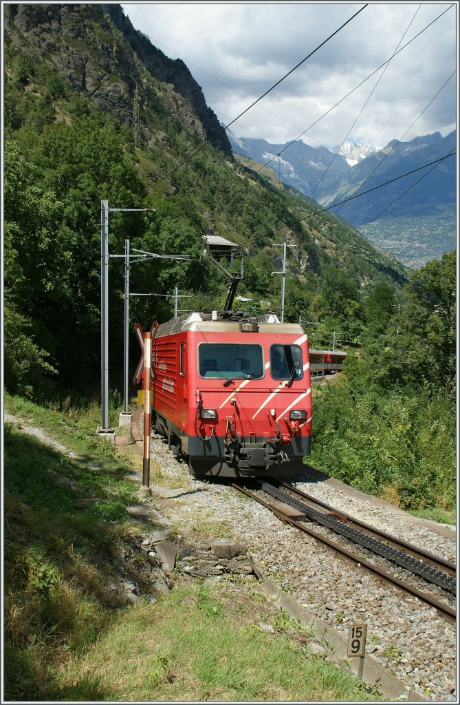 The MGB  Mattherhorn Gotthard Bahn  HGe 4/4 is on the way to Brig. 
Pictured by Stalden, the 22. 07.2012