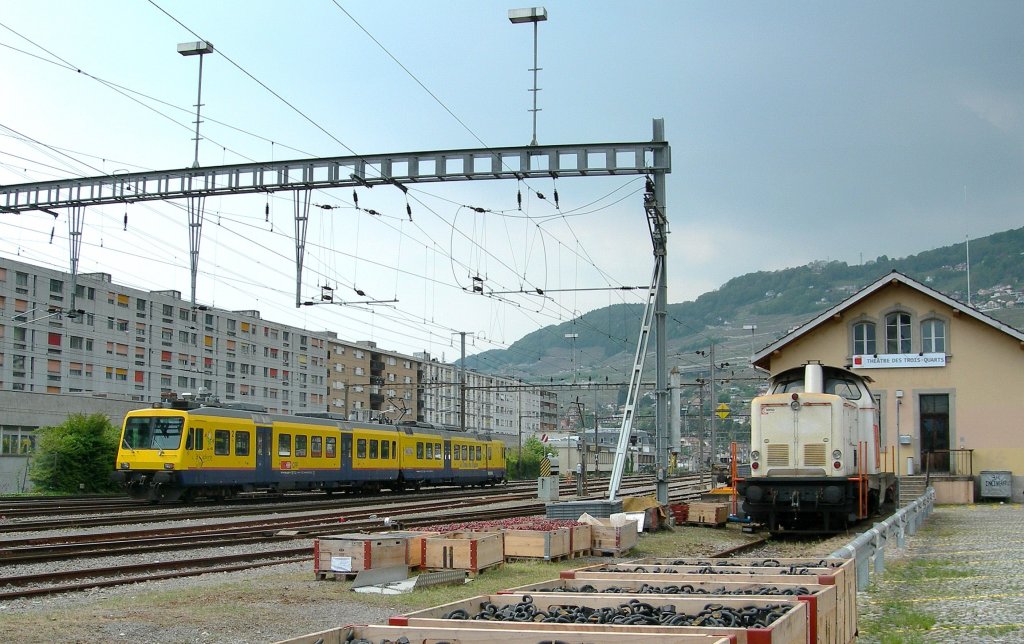 The  Train des Vignes  (Vineyard train is running to Puidoux Chexbres an the Am 847 957-8 takes a Sunny Day-Break in the Vevey station area. 
16.05.2010