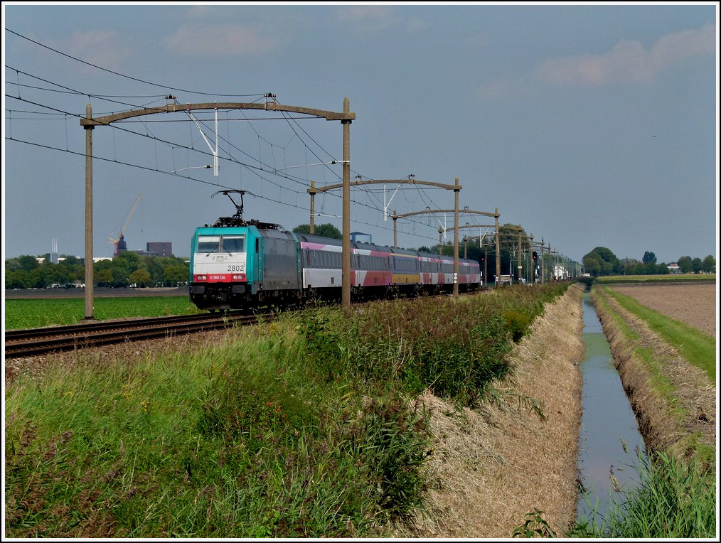 The TRAXX 2802 is heading the IC Amsterdam - Antwerpen near Zevenbergen on September 3rd, 2011.
