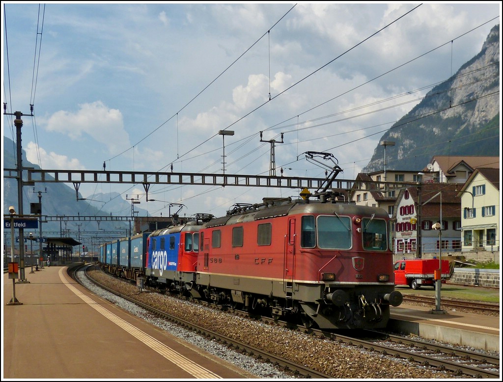 Two Re 4/4 II are hauling a goods train through the station of Erstfeld on May 24th, 2012.