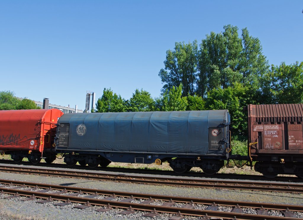 Wagon on bogies with four sets of wheels and sliding tarpaulin for coil transport (Sfhimmns) of the DB ex GE Rail Sevice (NL-GERS)  on 02.06.2011 in Herdorf (Germany). This covered  freight wagon is designed according to TSI, EN, UIC for RIV, TEN RIV and UK traffic operation.  CT shows signs for Channel Tunnel authorized.