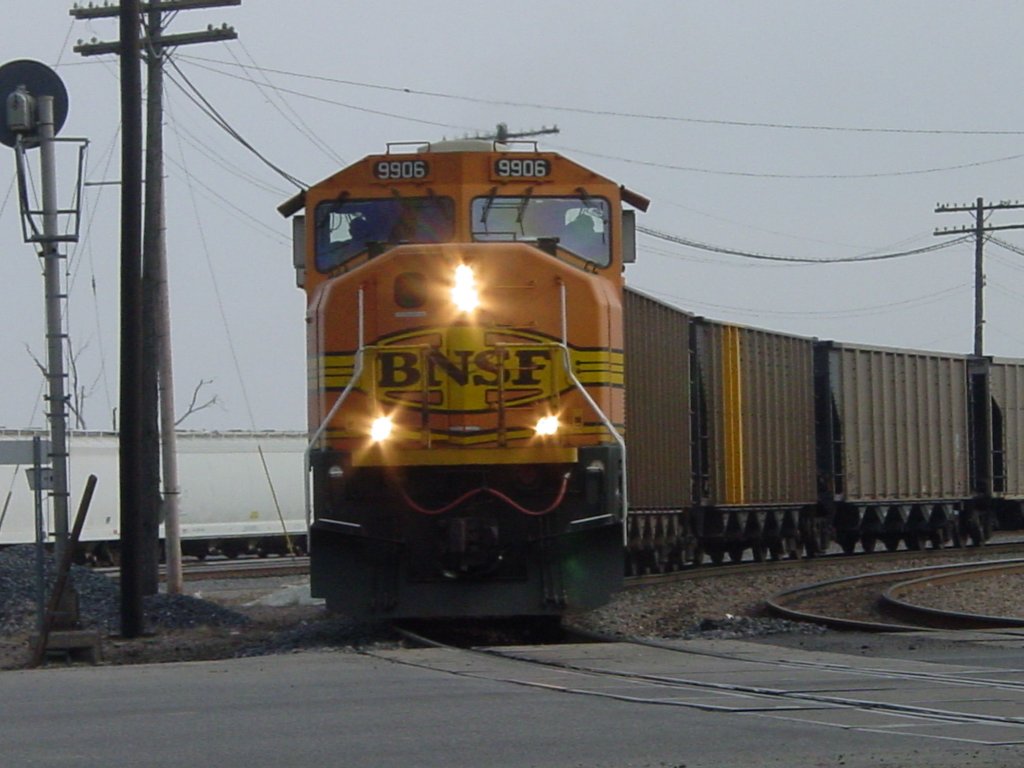 Westbound BNSF 9906 pulls its empty coal train thru the Burlington, Iowa yard and is about to enter the Main Street crossing on 27 Feb 2006. The engineer and conductor are seen in this photo.