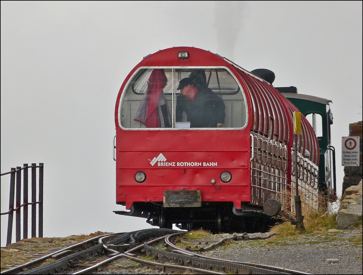 . A BRB train is leaving the summit station Rothorn Kulm on September 29th, 2013.