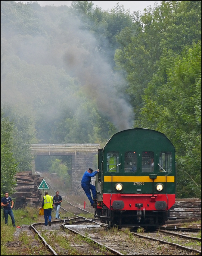 . A lot of smoke in the station Dorinne-Durnal on the heritage railway track Le Chemin de Fer du Bocq on August 17th, 2013.