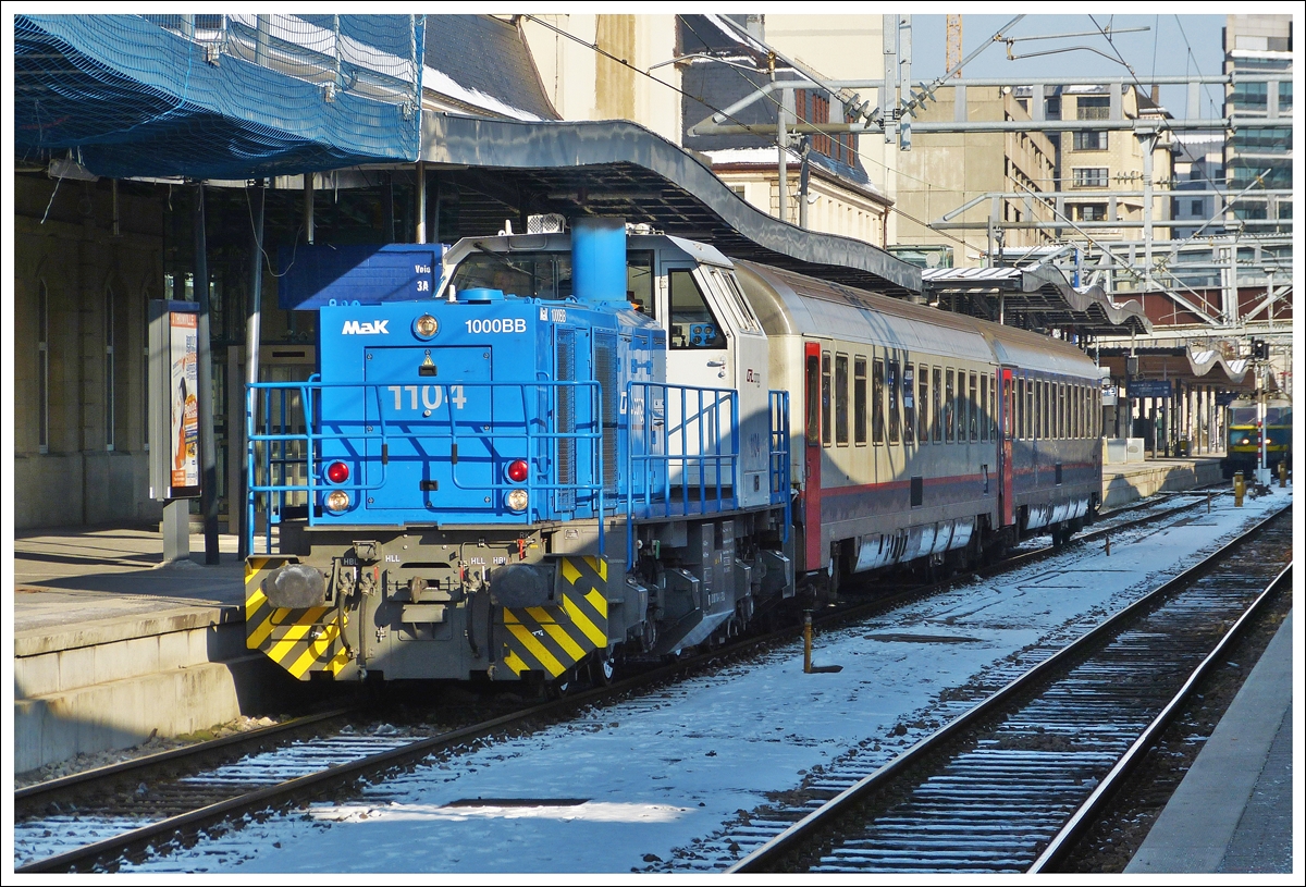 . The CFL Cargo 1104 is hauling two SNCB I 6 cars through the station of Luxembourg City on February 1st, 2012.