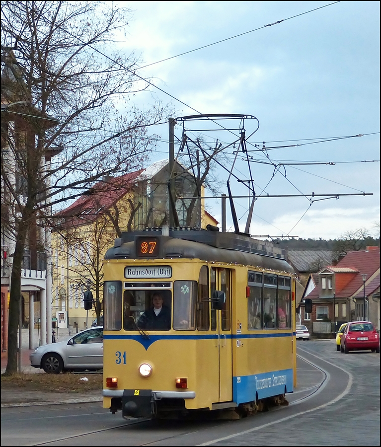 . The heritage tram N 31 of the Woltersdorfer Straenbahn is running through Berliner Strae in Woltersdorf on its way to Rahnsdorf (Bhf) on December 27th, 2012.