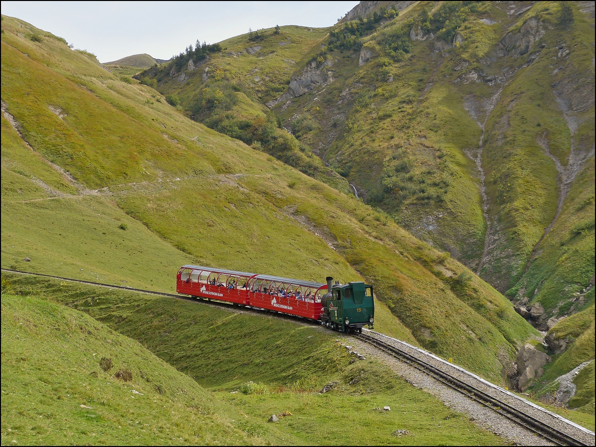 . The light oil fired BRB steamer N 15 is pushing its train towards the summit station Rothorn Kulm on September 28th, 2013.