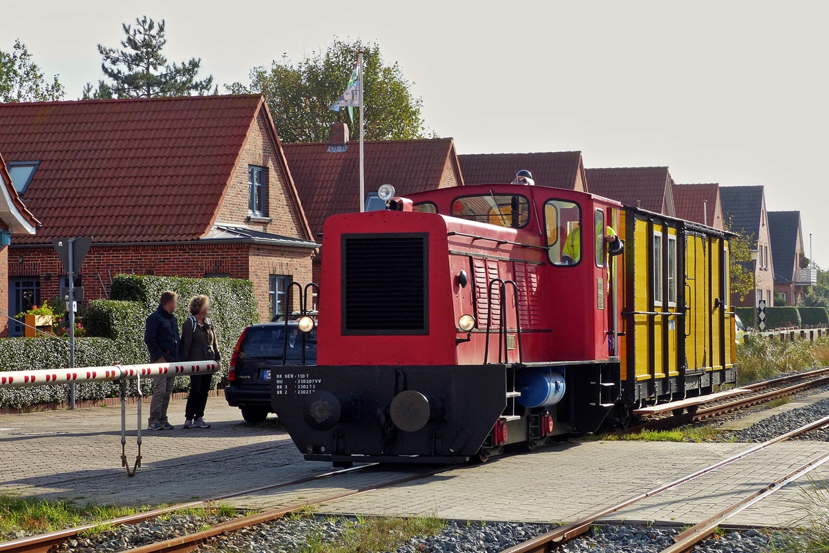 . The narrow gauge Diesel engine  Münster  is hauling the heritage waggon N° 48 on the track of the Borkumer Kleinbahn on October 8th, 2014.