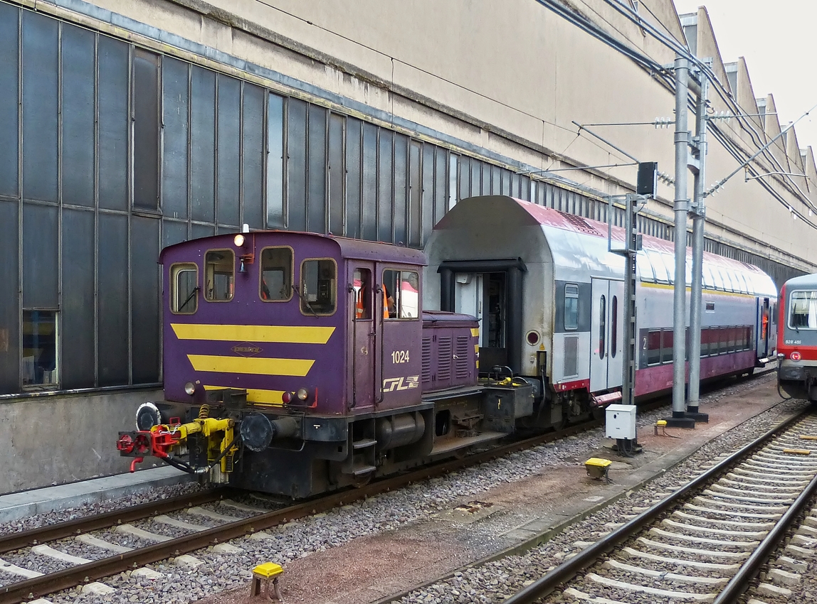 . The shunter engine 1024 is hauling a bi-level car through the station of Luxembourg City on July 15th, 2014.