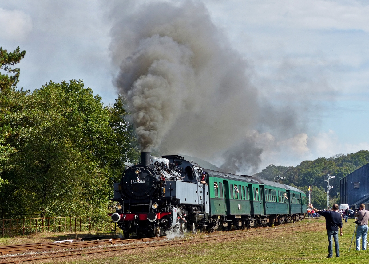 . The steam engine 64 250 of the heritage railway CFV3V (Chemin de Fer à Vapeur des 3 Vallées) is leaving the station of Treignes on September 27th, 2014.