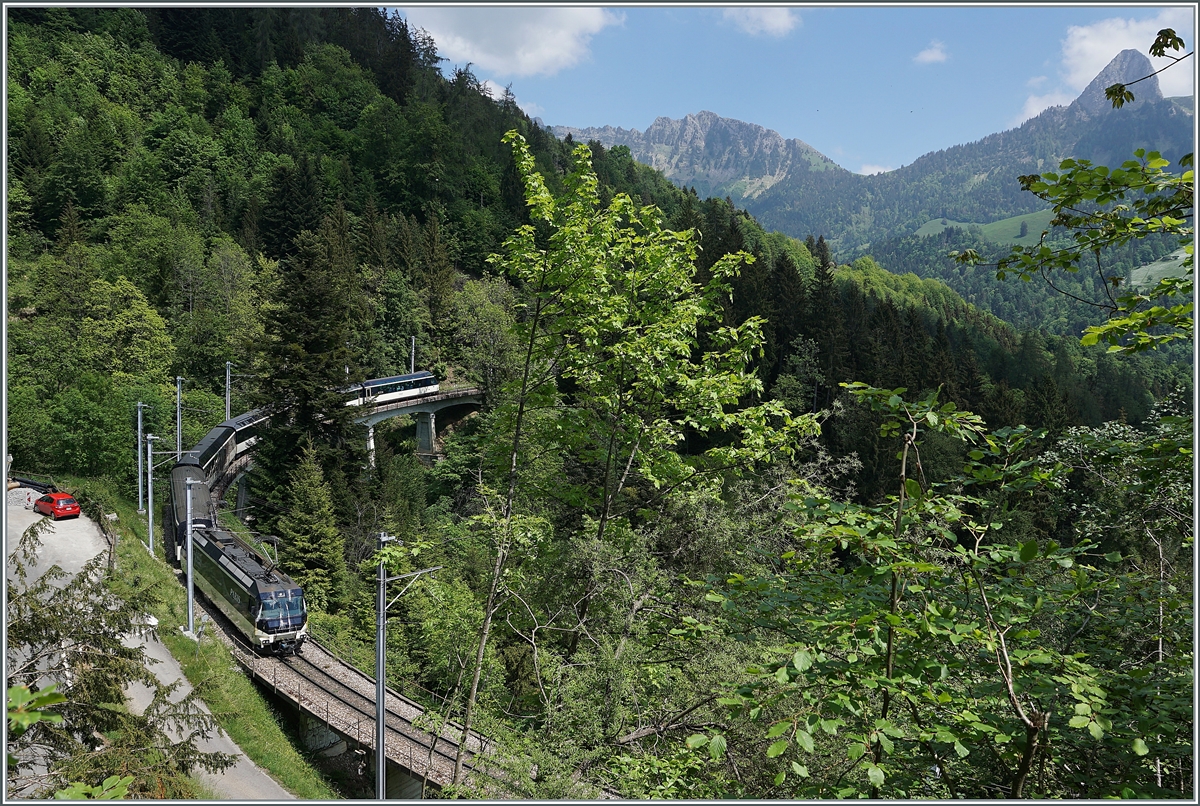 A MOB Ge 4/4 Serie 8000 wiht a MOB Panormaic Express Service on the way to Montreux on the Bois des Chenaux Bridge near Les Avants.

17.05.2020.