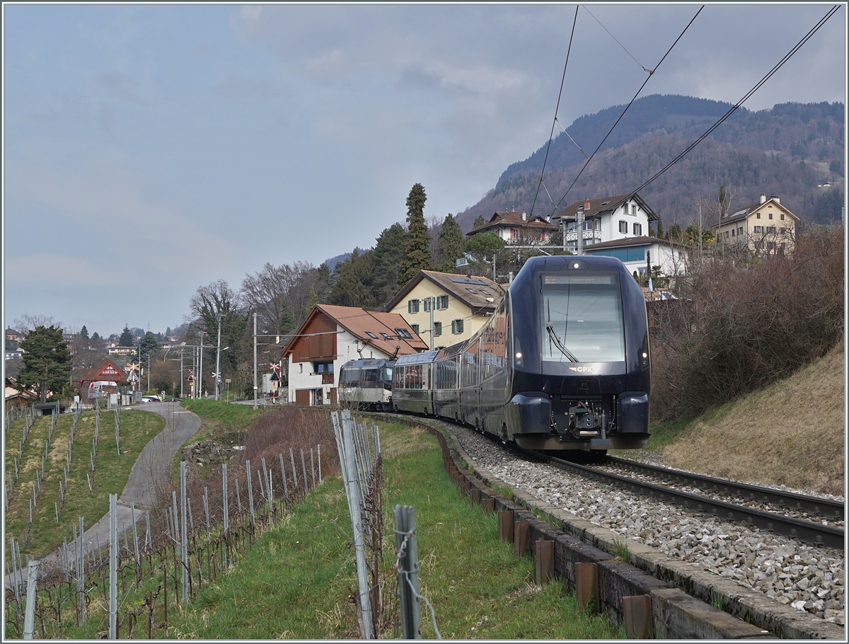 A MOB Ge 4/4 Series 8000, barely visible at the rear of the train, pushes its GoldenPass Express 4065 towards Montreux near Planchamp.

February 28, 2024