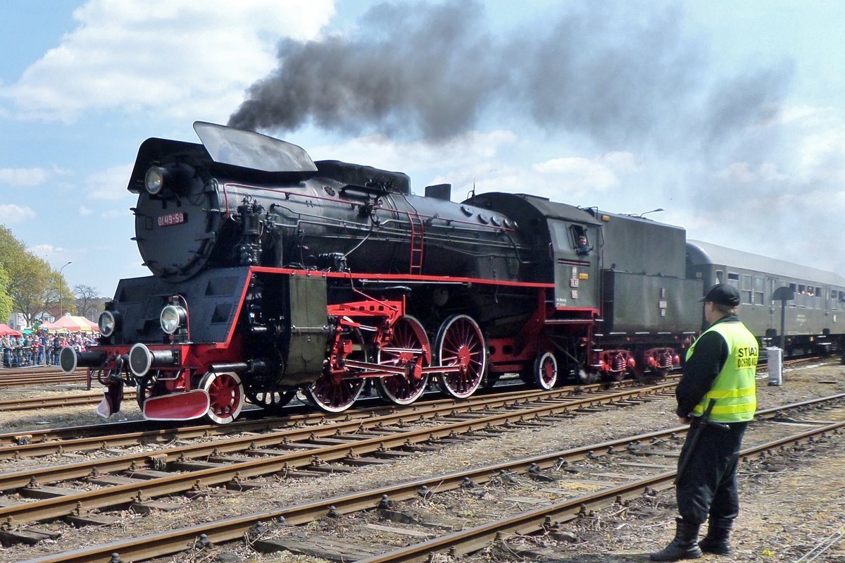 A railway police agent guards the incoming Ol49-59 with extra train from Leszno at Wolsztyn on 30 April 2016.