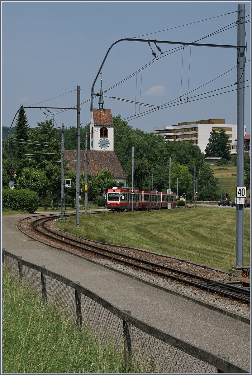 A WB (Waldenburger Bahn) local train by Oberdorf Winkelweg.
In the background the St Peter Church. 
 22.06.2017