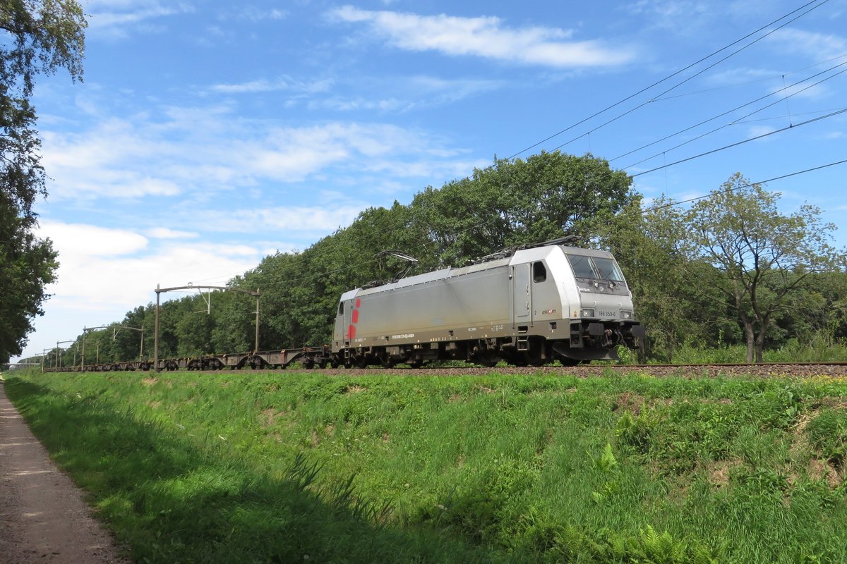 Akiem 186 359 hauls an empty container train through Tilburg Oude Warande on 19 July 2020.