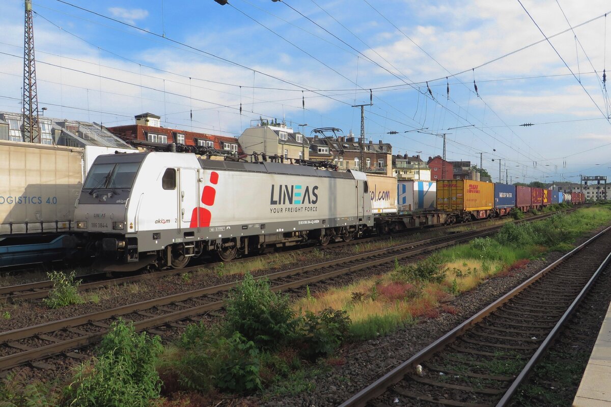 Akiem/Lineas 186 384 hauls a container train through Köln West on 19 May 2022. The weather, still clement here, turned monstruous with thunder and lightning under a darkened sky within less than a minute later...