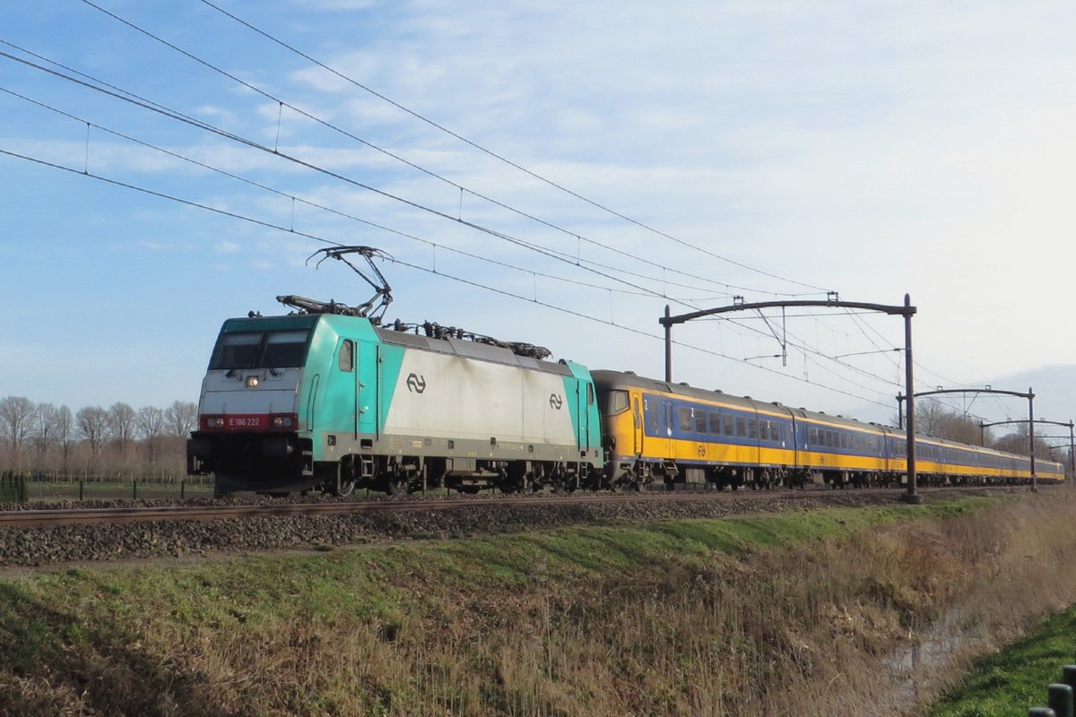 Alpha Trains 186 222 banks an IC-Direct through Oisterwijk on 23 February 2021.