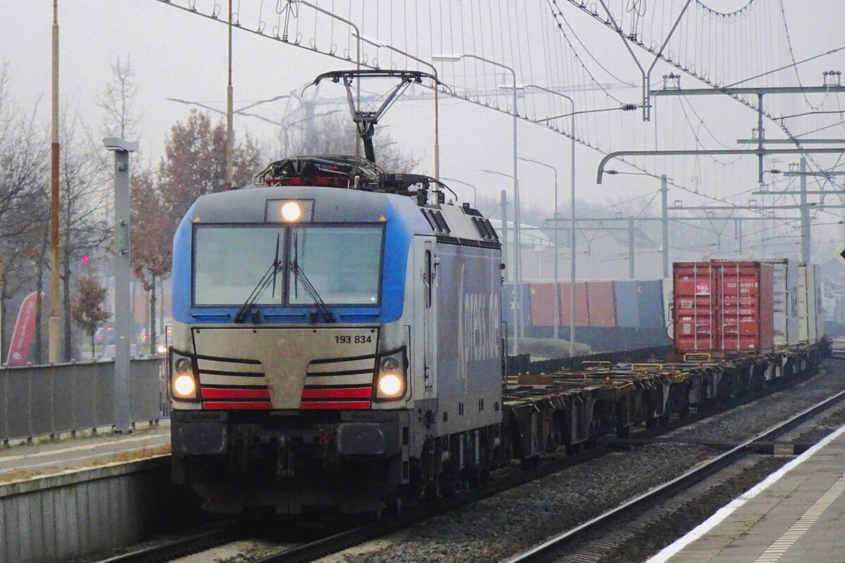 BoxXpress 193 834 hauls an intermodal train through Blerick on 16 December 2021.