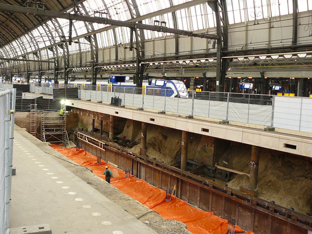 Building of a new wider tunnel under tracks 11, 12 and 13 Amsterdam Centraal Station 16-02-2012.