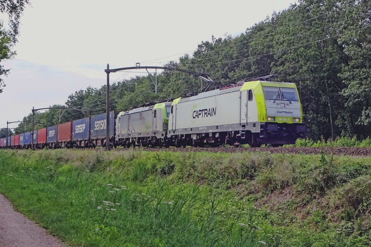 Captrain 186 151 hauls a BLS Vectron and a conatiner train through Tilburg Oude warande on 4 August 2019.