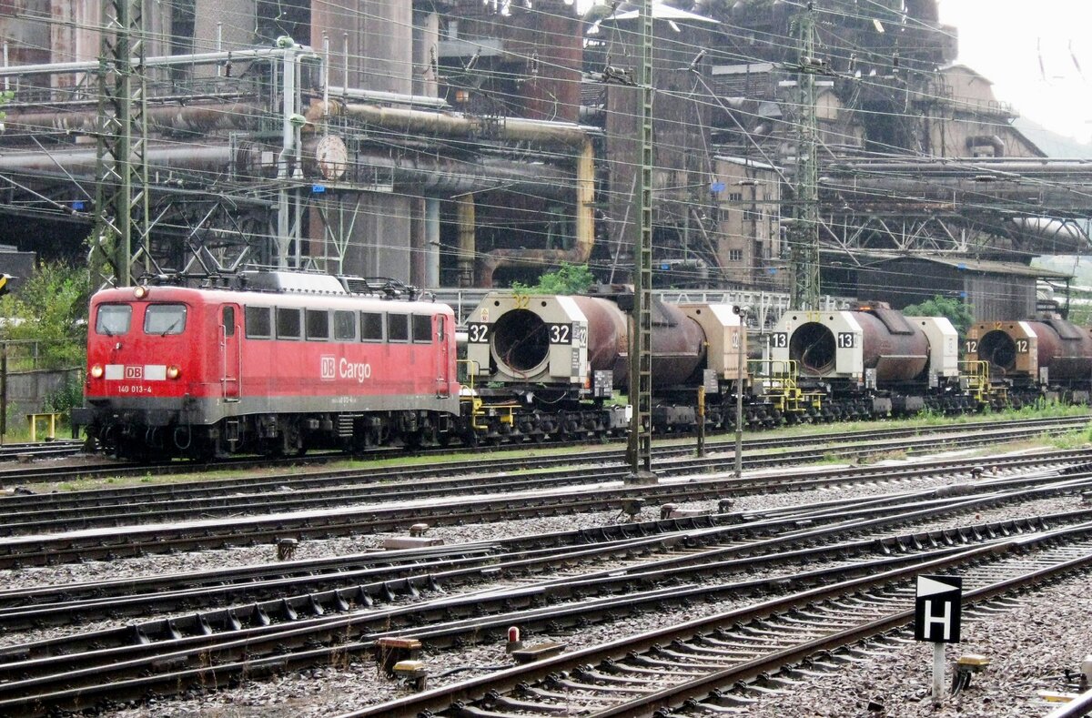DB 140 013 hauls a train of torpedo wagons loaded with molten steel past the old steel works at Völklingen on a rainy 16 September 2011.