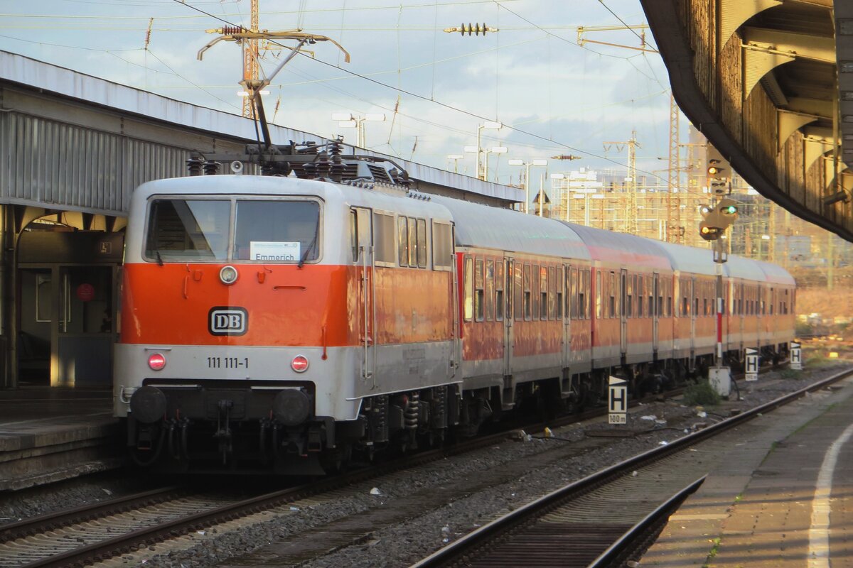 DB retro-liveried 111 111-1 pushes a peak hour train to Emmerich out of Oberhausen Hbf on 14 February 2022.