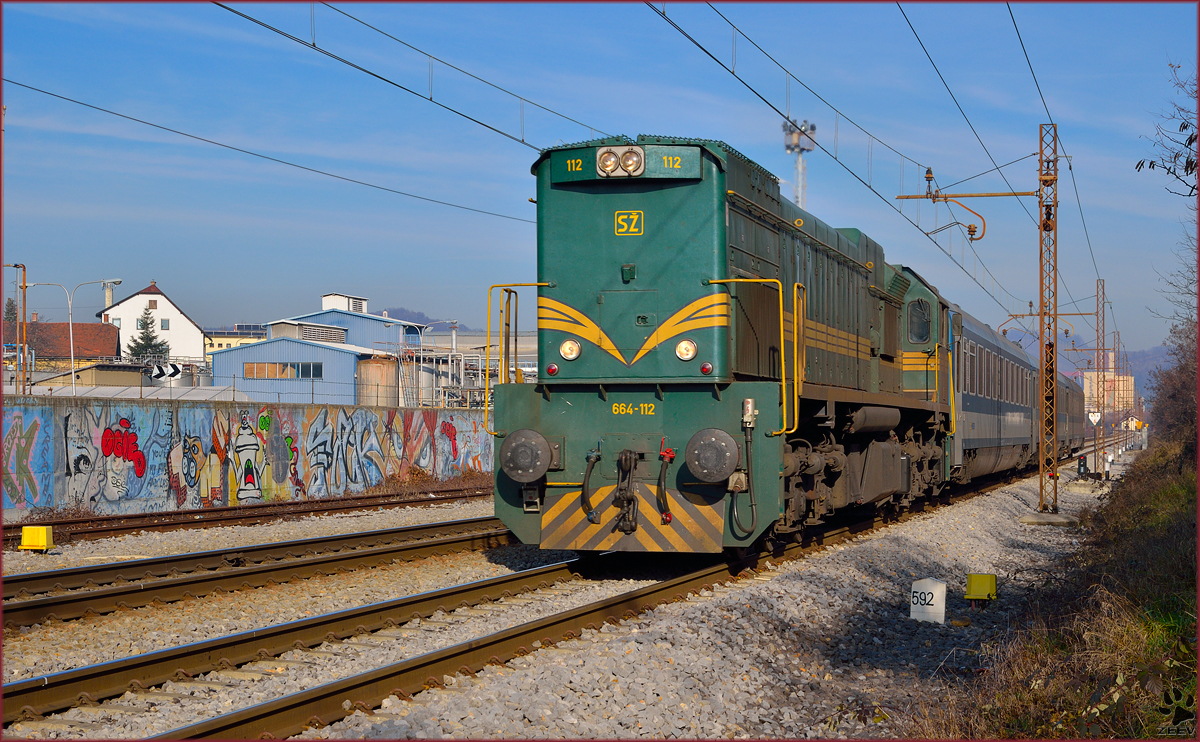 Diesel loc 664-112 is hauling MV247 'Citadella' through Maribor-Tabor on the way to Budapest. /23.12.2013