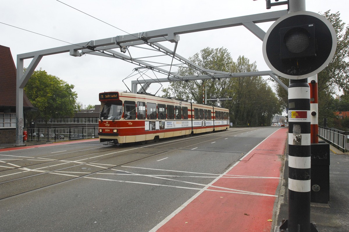 HTM 3004 in Delft. Line 1. The street is going downhill on the bridge. That's why the tram isn't running equal on the photo.

Date: 9. October 2011.